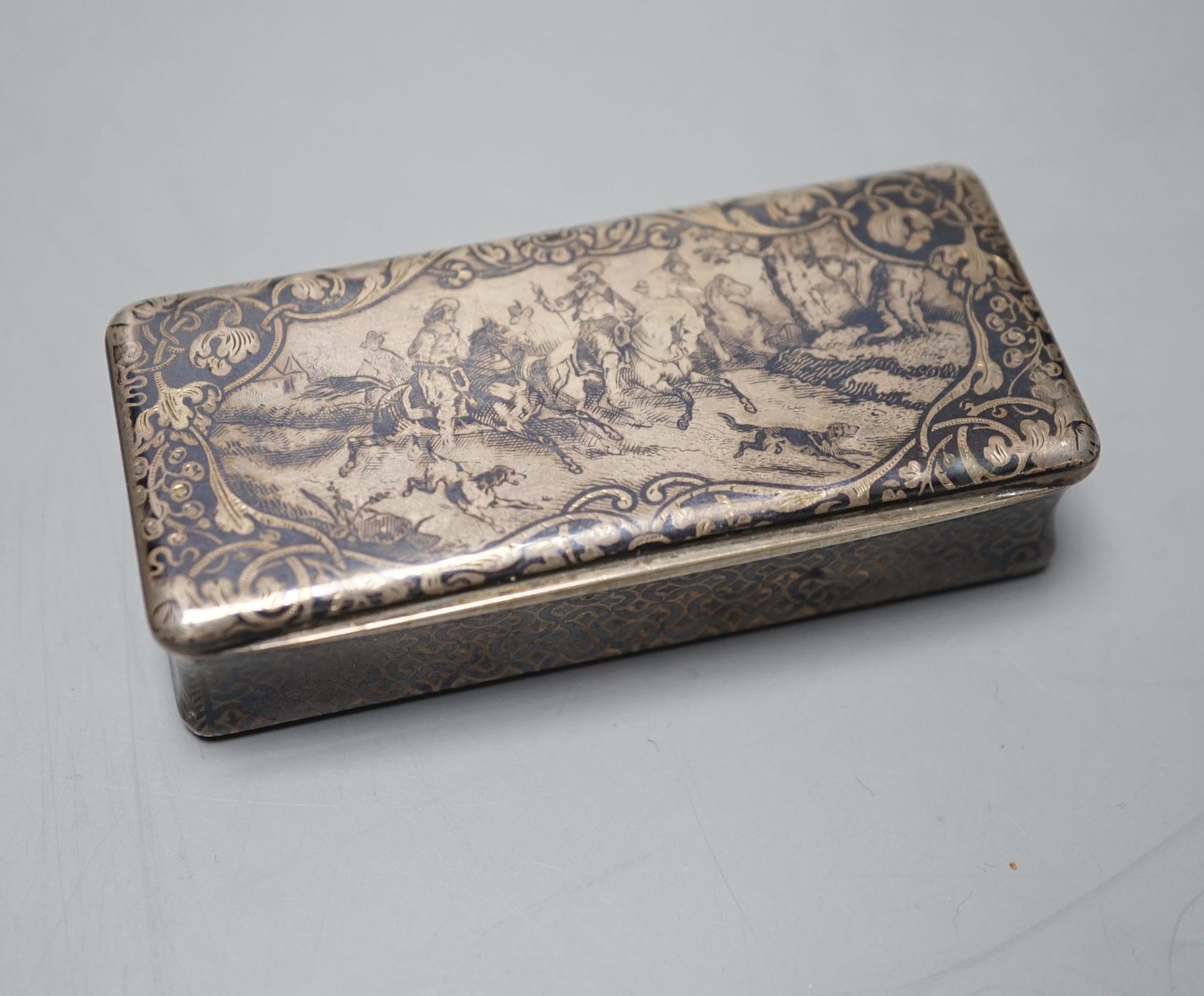 A 19th century French white metal and niello snuff box, decorated with hunting scene, 78mm.